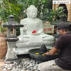Available - 4 Feet White Marble Abhaya Mudra Buddha Statue With Granite Lanterns And Urli Fountain